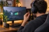 Un joueur ajuste le microphone d’un casque générique devant son ordinateur.
